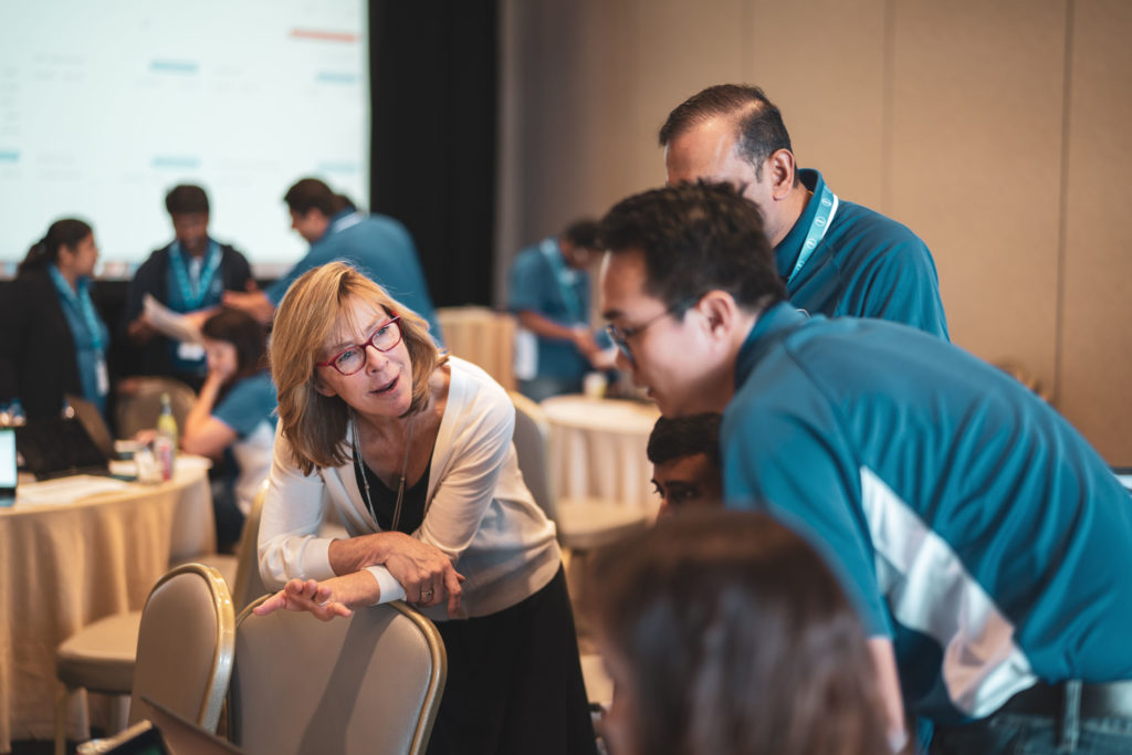 Participants in Abilitie's Rising Leader Program work with a certified facilitator during a business simulation