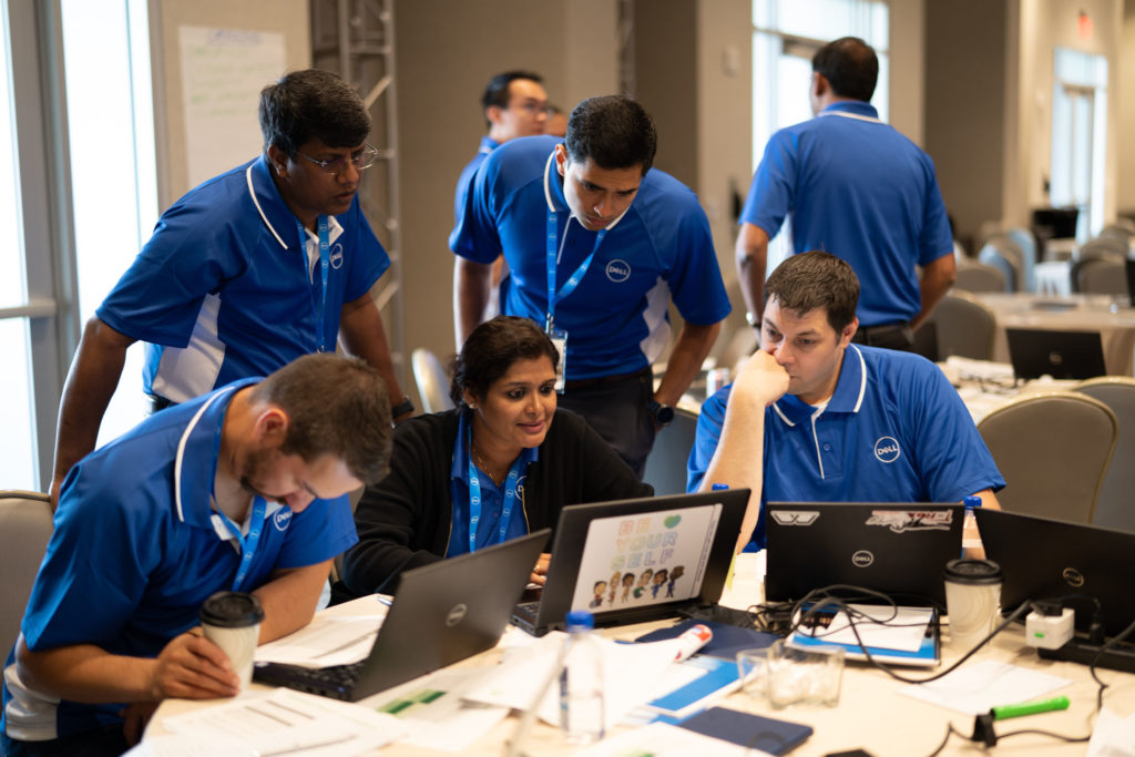 High-potential employees work together on a business simulation as part of the Rising Leader Program at a Fortune 500 technology company