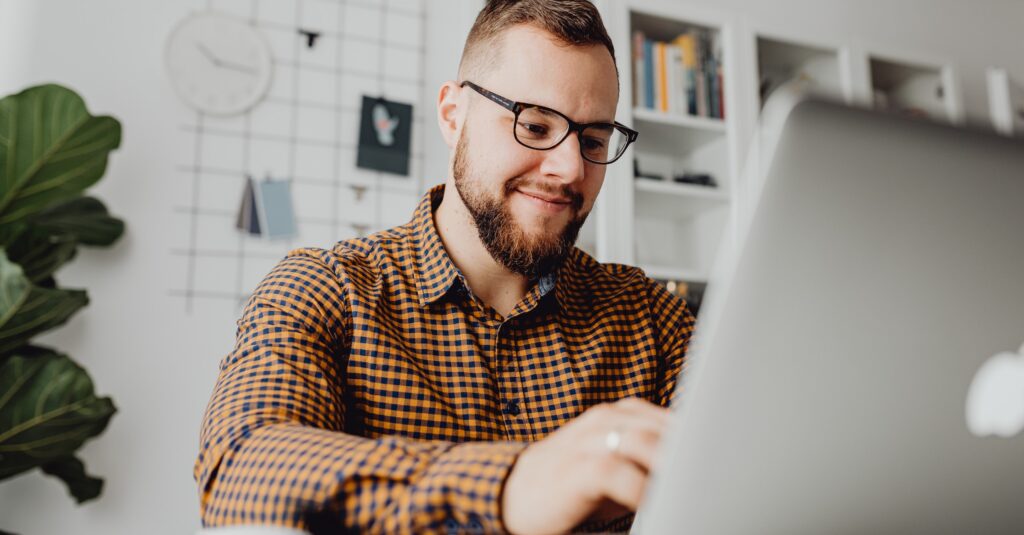 Young Male Manager Engaged In Virtual Training On Laptop